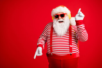 Fototapeta na wymiar Portrait of his he handsome bearded fat overweight cheerful cheery glad Santa meloman listen single hit sound rest dancing having fun isolated bright vivid shine vibrant red color background