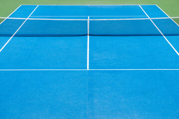 Outdoor tennis court painted in blue and green. Sports concept.	