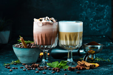 Coffee set: cocoa and hot chocolate with coffee beans. On a black background. Top view.