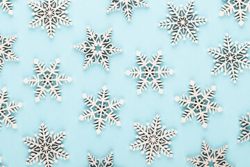 Christmas background. White snow decorations on a pink background.