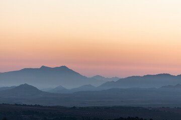 landscape of a sunrise with mountains and fields