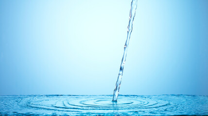 Pouring water on blue background