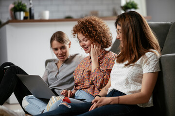 Girlfriends talking and laughing in office. Beautiful women drinking coffee in the office...