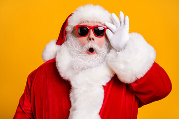 Close-up portrait of his he nice attractive amazed Santa father newyear celebration party pout lips touching specs bargain isolated over bright vivid shine vibrant yellow color background