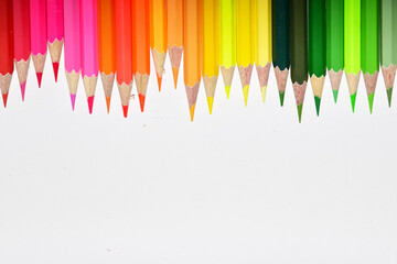 Many Color pencils isolated on white background close up. Color pencils for drawing as a background