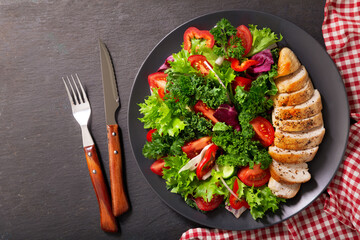 plate of chicken salad with vegetables, top view