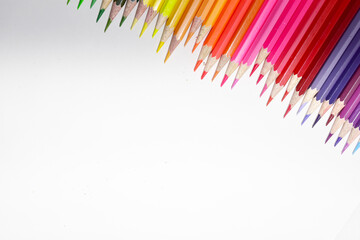 Many Color pencils isolated on white background close up. Color pencils for drawing as a background