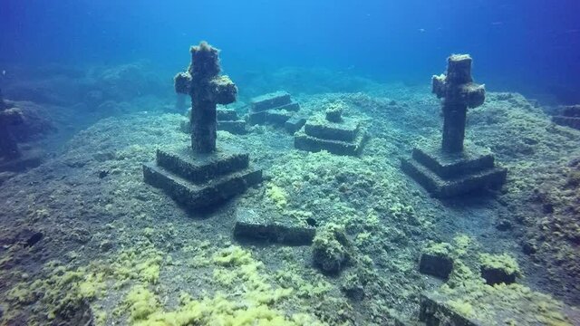 Crosses underwater in sunken cemetery on bottom of volcanic origin in Atlantic ocean. Relax video about undersea world on seabed of La Palma Canary Islands. Incredible rare footage.