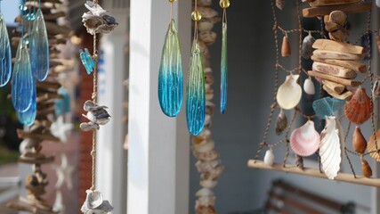 Nautical style hanging seashells decoration, beachfront blue wooden holiday home, pacific coast, California USA. Marine pastel interior decor of beach house in breeze. Summertime sea wind aesthetic