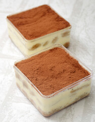 Tiramisu cake in a jar, on a white background