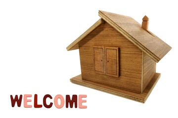 MINIATURE WOODEN HOUSE WRITING WELCOME. WITH COLOURED LETETRS. USABLE FOR REAL ESTATE, MORTGAGE, LOAN, RESTORATION HOME, PURCHASE OR SALE HOUSE.