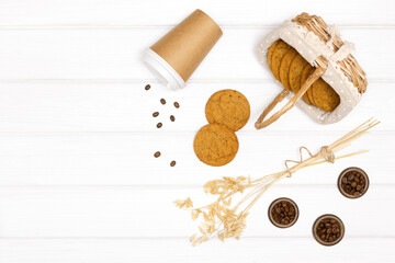 Oatmeal cookies with paper coffee cup on white wooden plank table. Copy space. Rustic healthy dessert. Sweets for coffee