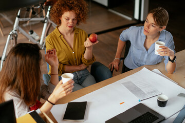 Businesswomen working on a new project. Colleagues discussing about problem they have to solved.