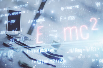 Desktop computer background and formula hologram writing. Double exposure. Education concept.
