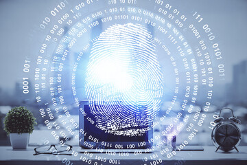 Computer on desktop in office with finger print drawing. Double exposure. Concept of business data security.