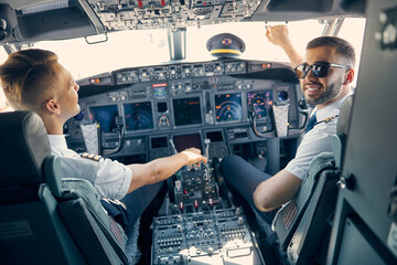 Two handsome male sitting in the cabin of aircraft © Svitlana