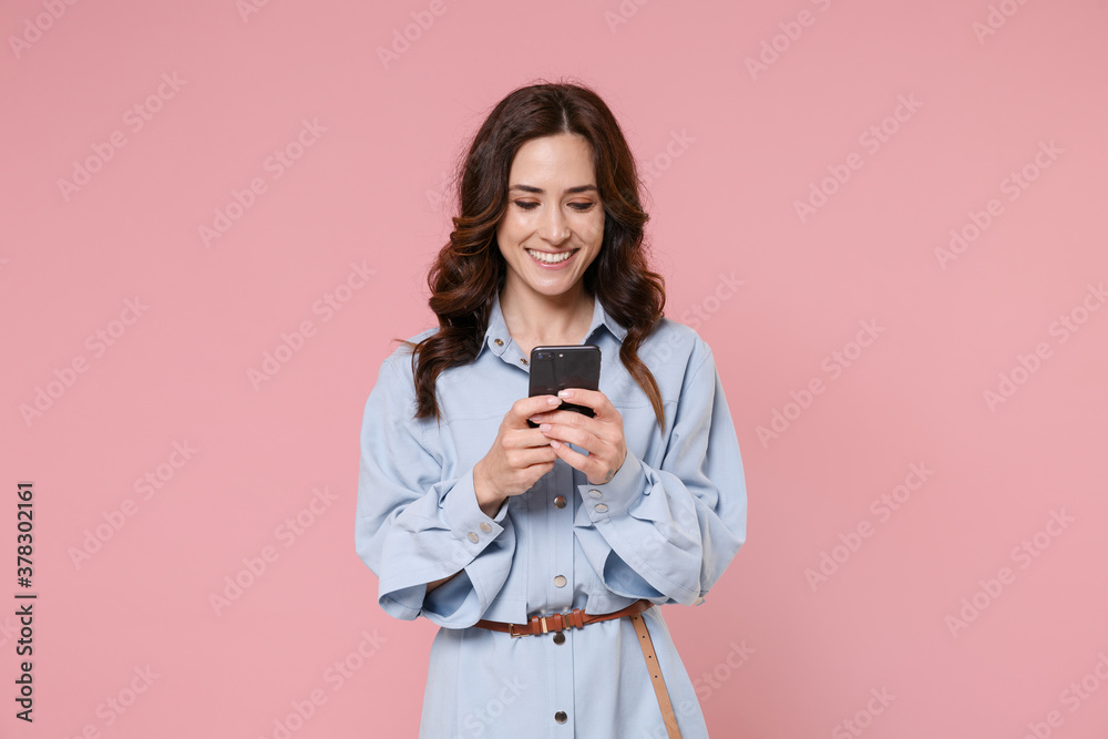 Wall mural smiling cheerful funny young brunette woman 20s wearing casual blue shirt dress posing standing usin