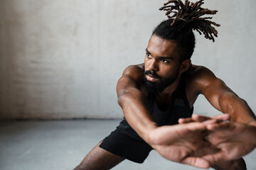 Image of african american sportsman doing exercise while working out