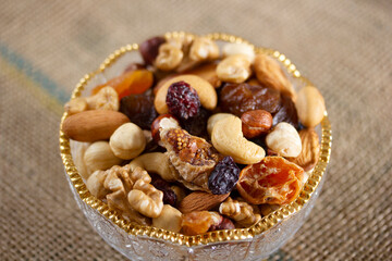 Mixed nuts in a glass plate. Healthy and natural nutrition .Cashew, Almond,, Hazelnut,, Fig,, Walnut,, Apricot,, Raisin,, Blueberry.