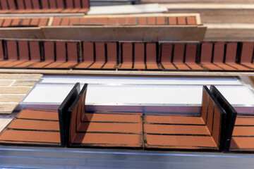 Industrial production of elastic clinker tiles. Modern technologies with the use of polymeric materials and natural clay. Facade ceramic tiles for exterior decoration of houses.