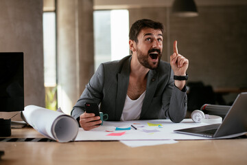 Young businessman working on projects. Handsome businessman in suit working in the office....