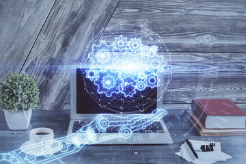 Double exposure of desktop computer and technology theme hologram. Concept of software development.