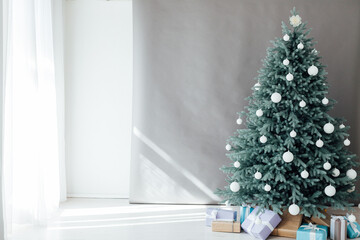 Blue Christmas tree with pine decor gifts for the new year in the interior