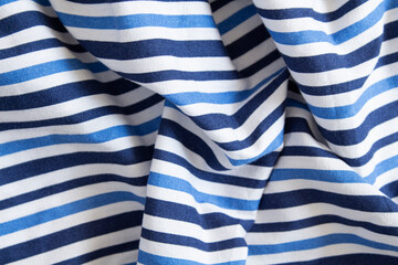 Fototapeta na wymiar Crumpled cotton fabric with blue stripes