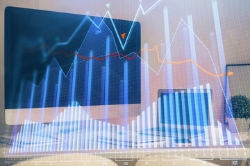 Financial chart drawing and table with computer on background. Double exposure. Concept of international markets.