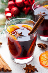Mulled red wine with spices, orange slices. New year and Christmas background. Close up.
