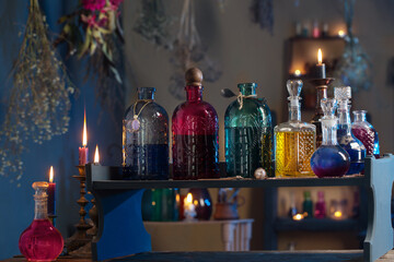 magic potions in witch's house with burning candles at night