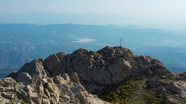 Aerial view mountain Mount Khustup (3,206 m).
Metal cross on the mountain.It is the most recognized mountain in the region.It is the symbol of Kapan and overlooks the city with an impressive presence.