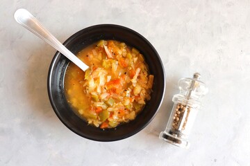 Body cleansing & detox Homemade Weight Loss Wonder Soup. veg soup made of tomatoes, capsicums, carrots, cabbage and onions. seasoned with salt and pepper. Low calorie diet vegetables soup. copy space.
