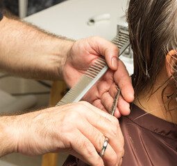 Professional hairdresser cutting a woman's hair