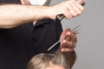Professional hairdresser cutting a woman's hair