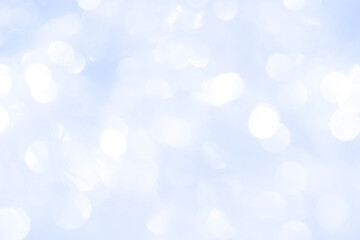 Bokeh light on blue background, sky with circle glitter light blue. Snow abstract soft glowing with vivid bright light and bokeh blur effect. 