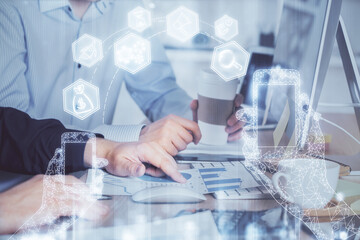 Fototapeta premium Technology theme hologram with man working on computer on background. High tech concept. Multi exposure.