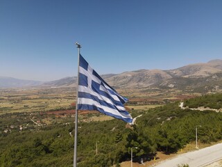 Greek flag waving over a mountain in Korilovos, Drama, Northern Greece