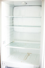 Fototapeta premium Broken fridge. defrosted refrigerator. Open freezer