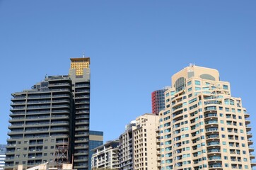 Fototapeta premium Inner city apartments in the skyline against a deep blue sky in Sydney Australia