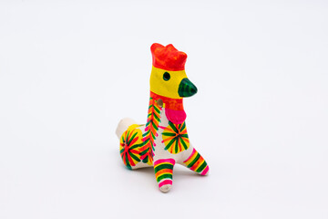 Ceramic whistle painted  cockerel isolated on white. Russian traditional kids toy musical wind instrument, horn.