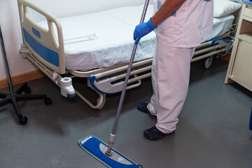 Conceptual photo of a hospital worker cleaning a patient room