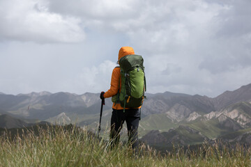 Backpacker hiking on high altitude mountain top
