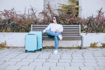 Travelling woman with luggage on her way to the airport.