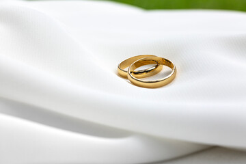 wedding rings on white fabric