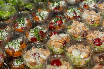 Salads in portioned plastic containers. Close-up.