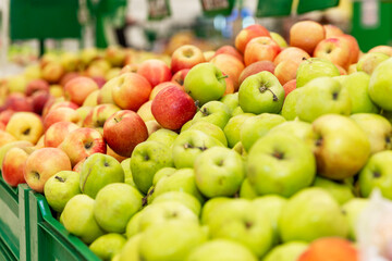 Assortment of apples in the supermarket. Large selection of different varieties. Healthy eating and vegetarianism. Side view.