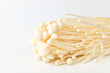 Enoki mushrooms on a white background