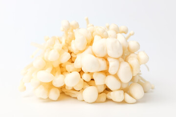 Enoki mushrooms on a white background
