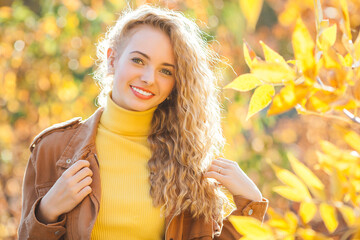 Attractive young girl on autumn background